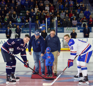 READY FOR ACTION: Joe Piscitello, his son Evan and brother, Local 888 leader Nicholas Piscitello, get ready to drop the puck as UMass Lowell and UConn players face off before the Nov. 17 game.