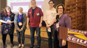 ON THE MOVE: From left, Shaylin Hogan and Dennis Levine, from Emerson College, and public defender John Sadek talk with Local 888 President Brenda Rodrigues about organizing.