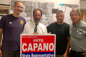 VICTORY PARTY: Pete Capano, holding a sign, and his supporters – including, from left, Local 888 organizer Ian Andelman, field rep Larry Higgins and staff chief Rand Wilson – had much to celebrate on primary day.