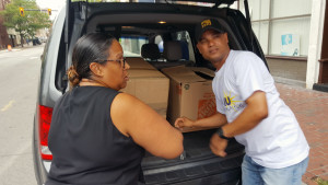 SPECIAL DELIVERY: Local 888 member Pedro Ayala, right, helps make deliveries in Lawrence to aid victims of the natural-gas disaster that shook the area. Recovery work continues