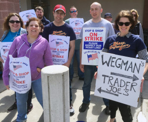 PITCHING IN: Local 888 was on the picket line in Medford with then-striking supermarket workers in Medford. From right, the new chapter chair of the MassDefenders, Rachel Scotch, Daniel Werner and Local 888 organizer D.J. Cronin, wearing a Sox cap. 