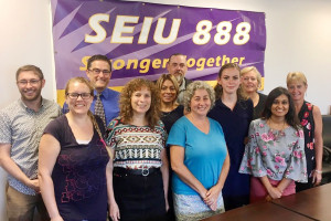 HEALTHY SUPPORT: Local 888 members and staff along with health and safety professionals were there for a report on custodians’ health and safety given by, in front at right, Sheba Saji and Ellie Prickett Morgan, immediately to her left. 