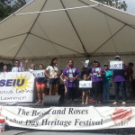 Members of Local 888's Latino Caucus join other SEIU members for a skit on the main stage at the Bread & Roses Festival in Lawrence. 
