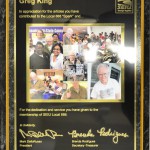 The plaque says, "Greg King: In appreciation for the articles you have contributed to the Local 888 "Spark" and for the dedication and service you have given to the membership of SEIU Local 888." 