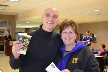 Local 888 Secretary-Treasurer Brenda Rodrigues with Andrew Alfano, a systems manager at UMass Lowell. Alfano is showing off the Bruins tickets he won at the recent Local 888 Hockey Night. 