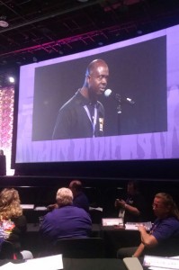 Kwesi Ablordeppey (pictured on the convention monitor) spoke out against racism and other social injustices at the SEIU convention