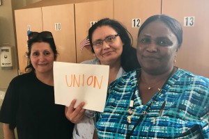SOLIDARITY: Local 888 members Rosa Matías, Mirna Polanco and Suze St.Val at the Chelsea Soldiers Home show which side they’re on after the Supreme Court’s Janus decision.