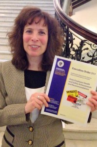 Marcy Goldstein-Gelb, executive director of the Massachusetts Coalition for Occupational Safety and Health pictured with a copy of the Advisory Committee's new report